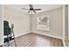Comfortable bedroom featuring a window and wood look flooring at 6611 2Nd Ne Ave, Bradenton, FL 34208