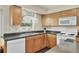 Well lit kitchen offering stainless sink, wood cabinets, and laminate flooring at 6611 2Nd Ne Ave, Bradenton, FL 34208