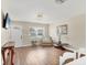 Inviting living room featuring laminate flooring, neutral paint, a TV, and comfortable furniture at 6611 2Nd Ne Ave, Bradenton, FL 34208