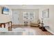 Inviting living room featuring laminate flooring, neutral paint, a TV, and comfortable furniture at 6611 2Nd Ne Ave, Bradenton, FL 34208