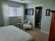 Inviting bedroom features a white chair and ensuite bathroom with a television at 6902 11Th W Ave, Bradenton, FL 34209
