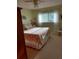 Comfortable bedroom features a window with blinds, creating a bright and welcoming space at 6902 11Th W Ave, Bradenton, FL 34209