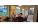 Bright dining area showcasing wicker chairs and views of lush landscaping at 6902 11Th W Ave, Bradenton, FL 34209