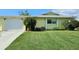 Charming single-story home features a well-manicured lawn and vibrant landscaping at 6902 11Th W Ave, Bradenton, FL 34209