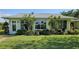 Charming single-story home with a well-manicured lawn, and green exterior at 6902 11Th W Ave, Bradenton, FL 34209