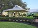 Picturesque gazebo in a lush garden setting offering a tranquil retreat in a serene community at 6902 11Th W Ave, Bradenton, FL 34209