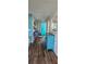 Inviting hallway with bright blue door and views to other rooms at 6902 11Th W Ave, Bradenton, FL 34209