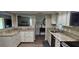 Bright kitchen with pass through and stone counters boasts natural light at 6902 11Th W Ave, Bradenton, FL 34209