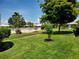 Well-manicured green lawn with lush landscaping featuring flowers, palms and shrubs in a well-kept community at 6902 11Th W Ave, Bradenton, FL 34209