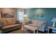 Inviting living room with two sofas and coastal accents throughout at 6902 11Th W Ave, Bradenton, FL 34209