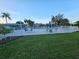 Pool area with white metal fence, outdoor seating, and lush landscaping offering a relaxing community space at 6902 11Th W Ave, Bradenton, FL 34209