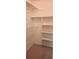 Walk-in closet with neutral carpeting and shelving to store personal items and clothing at 6902 11Th W Ave, Bradenton, FL 34209