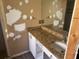 Bathroom with a vanity with granite countertops and a tiled shower at 6928 43Rd E Ct, Sarasota, FL 34243