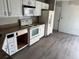 Kitchen with white appliances, light countertops, and wood flooring at 6928 43Rd E Ct, Sarasota, FL 34243