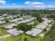 Aerial view of the real estate showcasing the community, pool, and proximity to the water at 7311 7Th W Ave # 7311, Bradenton, FL 34209
