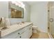 Bathroom featuring a large vanity, a framed mirror, and a glass-enclosed shower stall at 7311 7Th W Ave # 7311, Bradenton, FL 34209