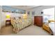A cozy bedroom featuring colorful bedding, wooden furniture, and nautical-themed decor at 7311 7Th W Ave # 7311, Bradenton, FL 34209
