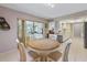 Well-lit dining area open to kitchen, with a round table, comfortable chairs, and sliding doors at 7311 7Th W Ave # 7311, Bradenton, FL 34209