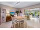Cozy dining area with a round table and four chairs, featuring sliding glass doors leading to the lanai at 7311 7Th W Ave # 7311, Bradenton, FL 34209