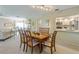 Spacious dining area featuring a large wooden table with seating for six, open to the kitchen and living area at 7311 7Th W Ave # 7311, Bradenton, FL 34209