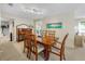 Elegant dining room with a large wooden table, six chairs, and a decorative buffet, bathed in natural light at 7311 7Th W Ave # 7311, Bradenton, FL 34209