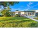 Charming home with lush landscaping, a sidewalk, and a welcoming front porch area at 7311 7Th W Ave # 7311, Bradenton, FL 34209