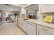 Bright kitchen with white cabinets, stainless steel hardware, quartz countertops, and an open floor plan at 7311 7Th W Ave # 7311, Bradenton, FL 34209