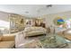 Bright living room featuring a glass coffee table, display cabinet and furniture, ideal for relaxing and entertaining guests at 7311 7Th W Ave # 7311, Bradenton, FL 34209