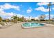 Inviting community pool area surrounded by lounge chairs and lush landscaping at 7311 7Th W Ave # 7311, Bradenton, FL 34209