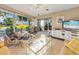Bright sunroom featuring tile floors, comfortable seating, and large windows offering scenic outdoor views at 7311 7Th W Ave # 7311, Bradenton, FL 34209