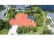 Aerial view of a single-Gathering home with a red-tiled roof, pool, and lush landscaping at 8005 Royal Birkdale Cir, Lakewood Ranch, FL 34202