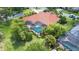 Aerial showcasing a private backyard with screened pool, mature landscaping, and terracotta tile roof at 8005 Royal Birkdale Cir, Lakewood Ranch, FL 34202