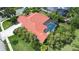 Aerial view showcases the red-tiled roof, screened-in pool, and well-manicured landscaping at 8005 Royal Birkdale Cir, Lakewood Ranch, FL 34202