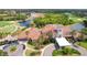 Aerial view of a golf community clubhouse with a tile roof and surrounding lakes at 8005 Royal Birkdale Cir, Lakewood Ranch, FL 34202