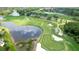 Aerial view of a golf course featuring lush green fairways, water features, and manicured sand traps at 8005 Royal Birkdale Cir, Lakewood Ranch, FL 34202