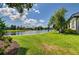 Expansive backyard with lush grass and views of the serene lake at 8005 Royal Birkdale Cir, Lakewood Ranch, FL 34202