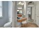 Bathroom with granite countertop, lighted mirror, tiled floors, a toilet and view to the bedroom at 8005 Royal Birkdale Cir, Lakewood Ranch, FL 34202