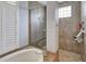 Bathroom featuring a walk-in shower, soaking tub, and a bright window at 8005 Royal Birkdale Cir, Lakewood Ranch, FL 34202