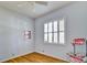 Bright, minimalist bedroom with hardwood floors, and shuttered window, creating a peaceful retreat at 8005 Royal Birkdale Cir, Lakewood Ranch, FL 34202