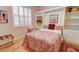Comfortable bedroom features a built-in Murphy bed, bookshelf, and light hardwood floors at 8005 Royal Birkdale Cir, Lakewood Ranch, FL 34202