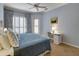 Comfortable bedroom features a ceiling fan, a door to the outside, and a functional desk with a chair at 8005 Royal Birkdale Cir, Lakewood Ranch, FL 34202