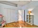 Well-lit bedroom with a closet, hardwood floors, and open door to the kitchen at 8005 Royal Birkdale Cir, Lakewood Ranch, FL 34202