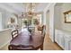 Bright dining room leads to the formal living room and offers a view of the lanai, pool and kitchen at 8005 Royal Birkdale Cir, Lakewood Ranch, FL 34202