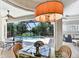 Dining area with a view of the screened pool, creating a relaxing and inviting ambiance at 8005 Royal Birkdale Cir, Lakewood Ranch, FL 34202