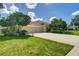 Spacious home featuring a wide driveway, a manicured lawn, and a three-car garage for ample parking at 8005 Royal Birkdale Cir, Lakewood Ranch, FL 34202