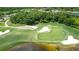 Aerial view of the golf course showcasing its green landscape, sand traps, and scenic water features at 8005 Royal Birkdale Cir, Lakewood Ranch, FL 34202