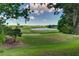 Picturesque golf course featuring rolling green hills, a tranquil lake, and mature trees at 8005 Royal Birkdale Cir, Lakewood Ranch, FL 34202