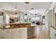 Spacious kitchen featuring a large island with seating, granite countertops, and stainless steel appliances at 8005 Royal Birkdale Cir, Lakewood Ranch, FL 34202