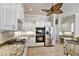 Kitchen featuring stainless steel appliances, gas range, granite countertops, and white cabinetry at 8005 Royal Birkdale Cir, Lakewood Ranch, FL 34202