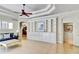 Open-concept living room with built-in shelving and decorative trim, perfect for entertaining guests at 8005 Royal Birkdale Cir, Lakewood Ranch, FL 34202